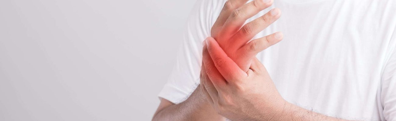 Palm pain concept : Close up man touching palm and feeling a pain. Studio shot isolated on grey background with copy space for text